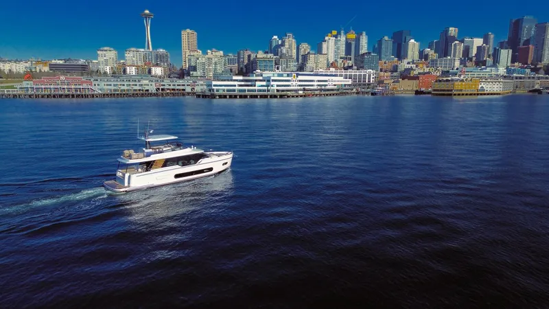 Slide: The Image of Azimut Magellano 60 yacht cruising near a city skyline, 2025 model. - 8