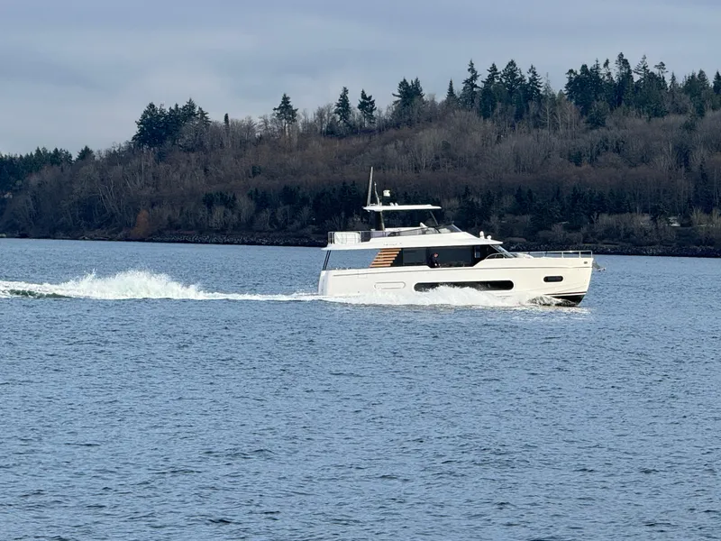 Slide: The Image of 2025 Azimut Magellano 60 yacht cruising on a serene lake. - 11