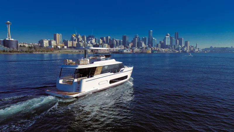 Slide: The Image of 2025 Azimut Magellano 60 yacht cruising near a city skyline. - 6