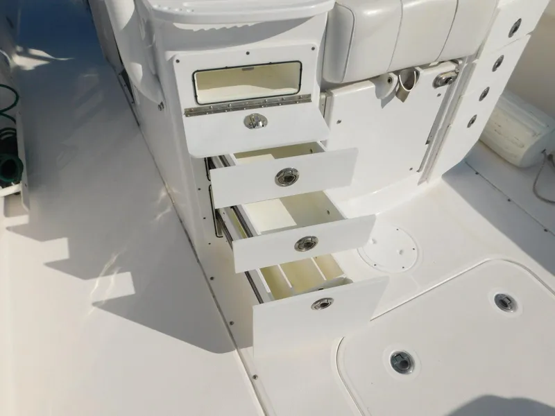 Slide: The Image of Open storage drawers on a 2016 Everglades 355 Center Console boat interior. - 26
