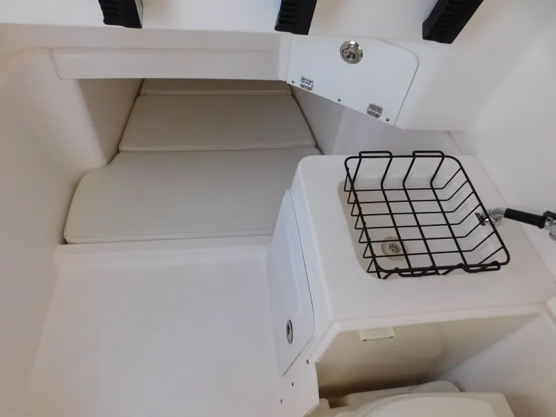 Slide: The Image of Interior of 2016 Everglades 355 Center Console boat with storage and seating area. - 36