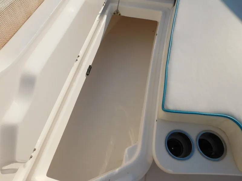 Slide: The Image of Open storage compartment on 2016 Everglades 355 Center Console boat with cup holders. - 41