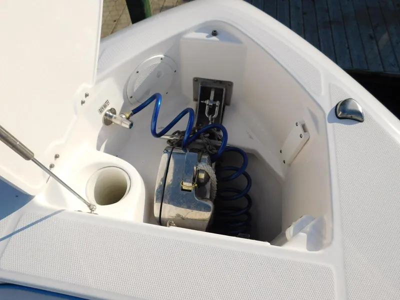 Slide: The Image of 2016 Everglades 355 Center Console anchor locker with coiled blue hose and winch system. - 43