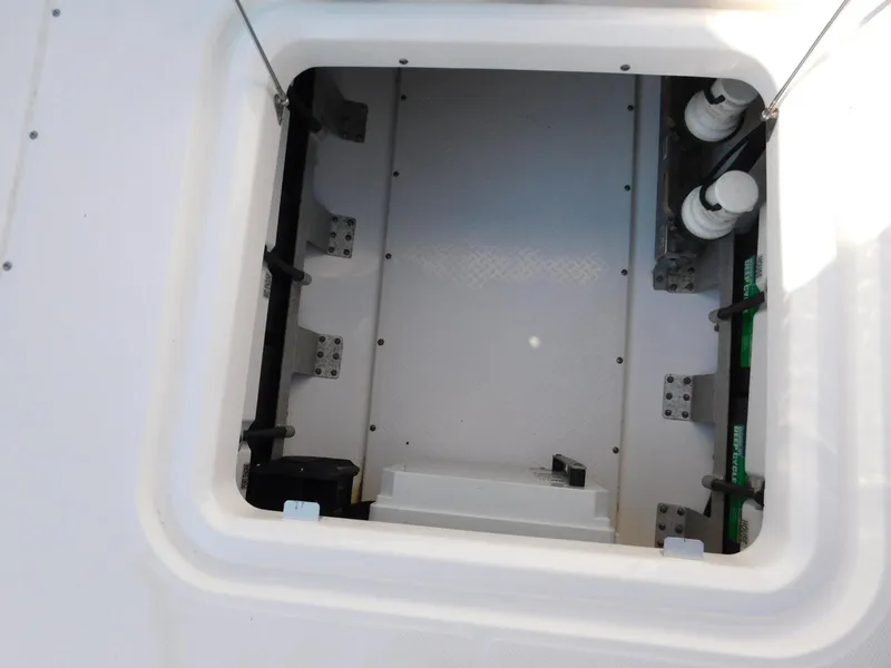 Slide: The Image of Open hatch of 2016 Everglades 355 Center Console boat, showing interior compartment. - 47