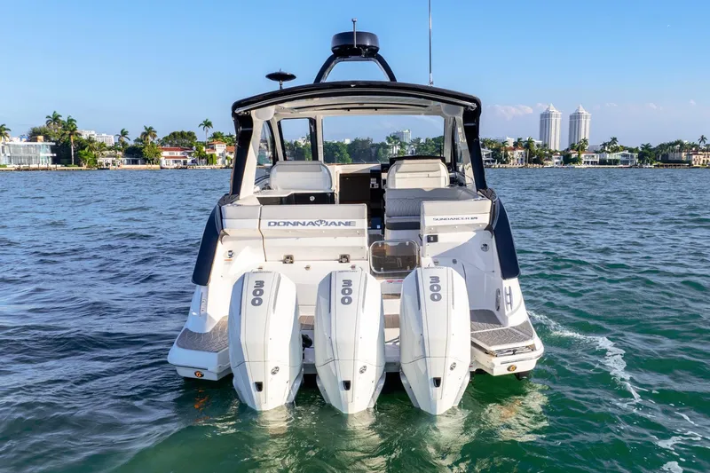 Slide: The Image of 2023 Sea Ray Sundancer 370 OB with triple outboard engines on the water. - 11