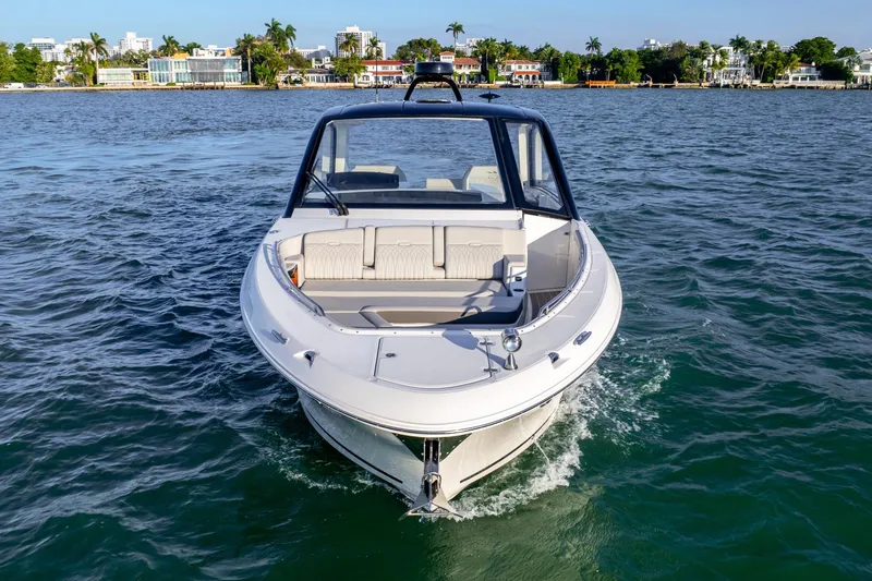 Slide: The Image of 2023 Sea Ray Sundancer 370 OB cruising on a sunny day near waterfront homes. - 13
