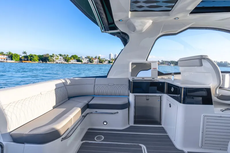 Slide: The Image of 2023 Sea Ray Sundancer 370 OB interior with luxurious seating and scenic water view. - 15