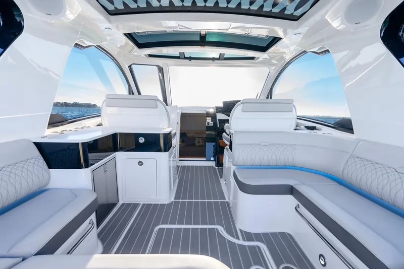 Slide: The Image of Luxurious interior of 2023 Sea Ray Sundancer 370 OB yacht with modern seating and panoramic windows. - 21