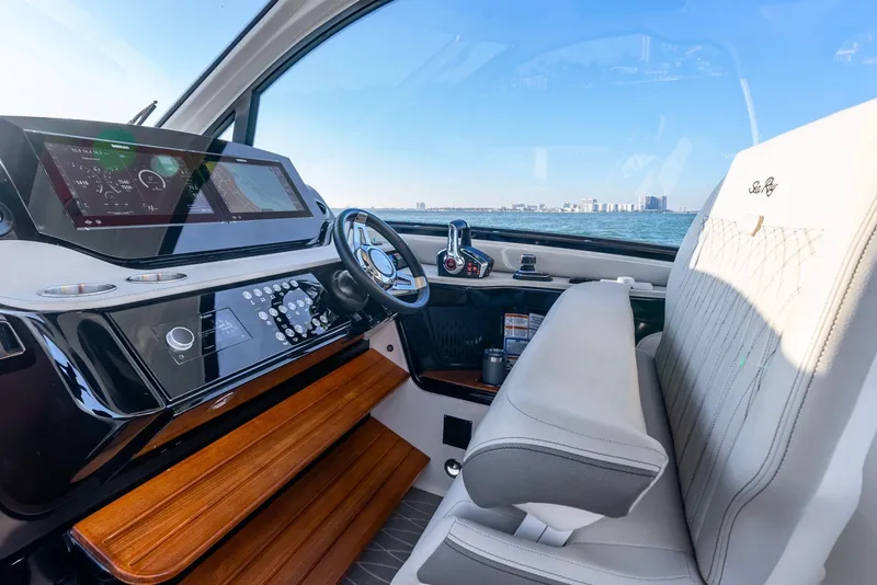 Slide: The Image of 2023 Sea Ray Sundancer 370 OB helm with modern controls and luxurious seating. - 22