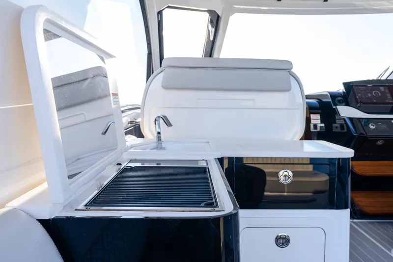 Slide: The Image of 2023 Sea Ray Sundancer 370 OB yacht interior with sleek kitchenette and modern design. - 23