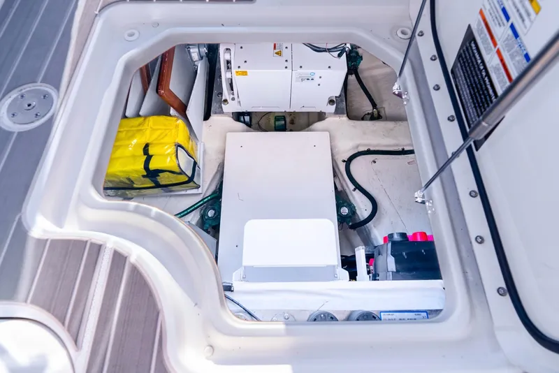 Slide: The Image of Engine compartment of 2023 Sea Ray Sundancer 370 OB with visible equipment and storage. - 24