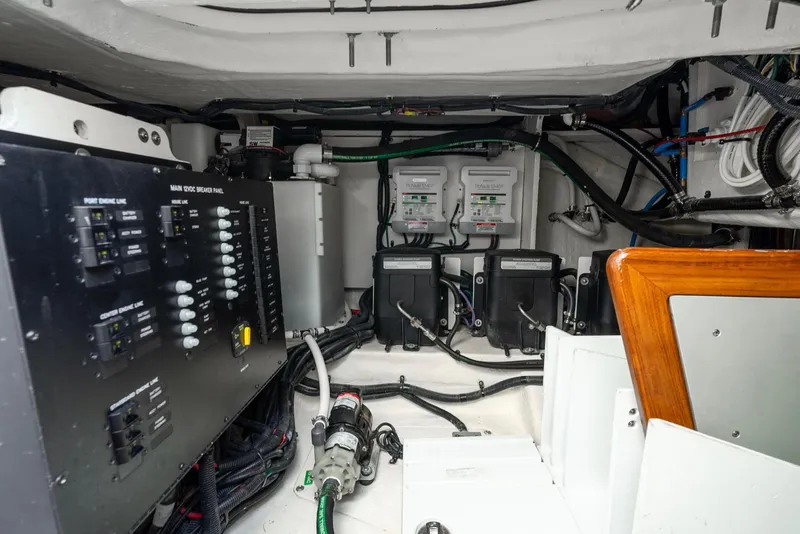 Slide: The Image of Engine room of 2023 Sea Ray Sundancer 370 OB with control panels and wiring. - 26