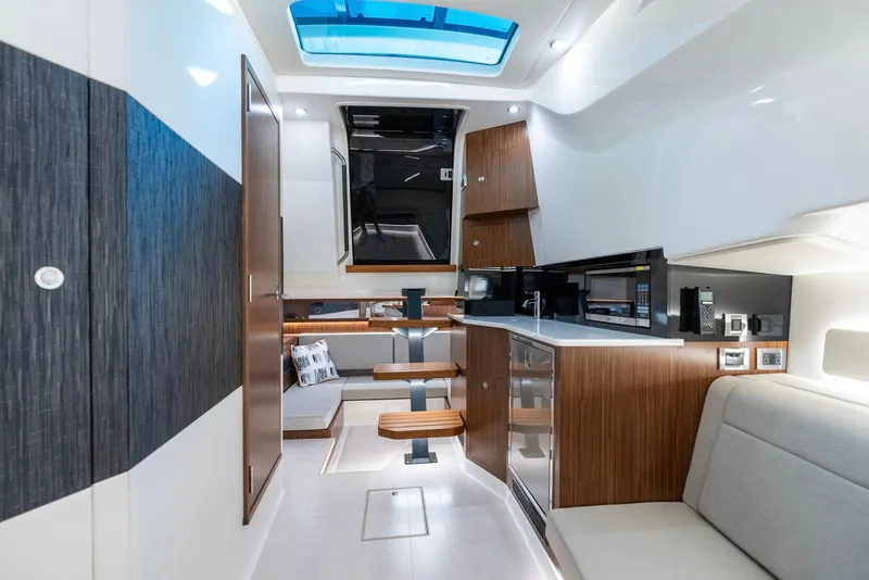 Slide: The Image of Luxurious interior of 2023 Sea Ray Sundancer 370 OB yacht with modern kitchen and seating. - 27