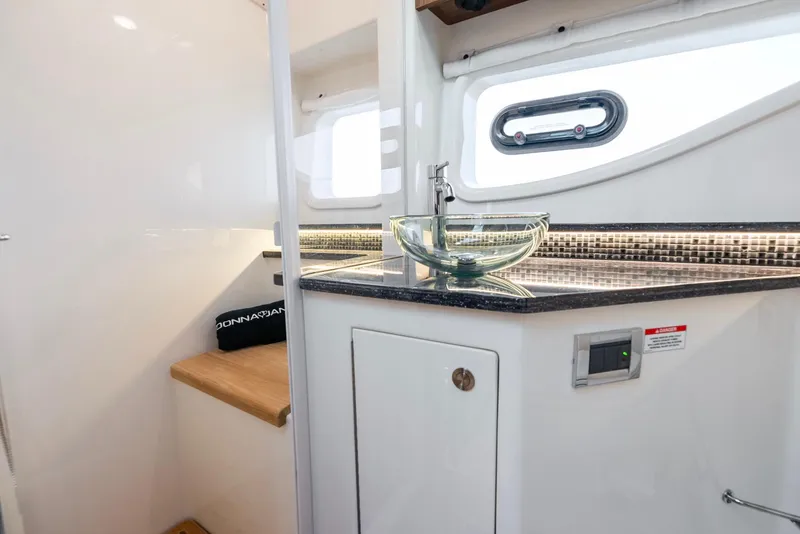 Slide: The Image of 2023 Sea Ray Sundancer 370 OB interior with modern sink and sleek design. - 35