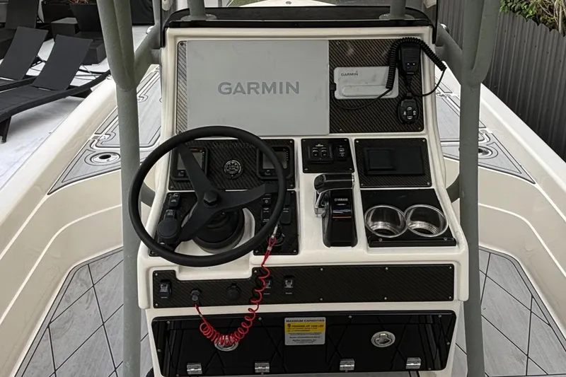 Slide: The Image of 2014 ShearWater 25LTZ boat console with Garmin navigation system and steering wheel. - 12