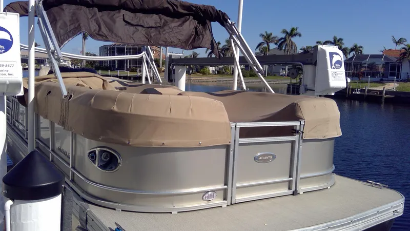 Slide: The Image of 2020 Landau Atlantis 250 Cruise pontoon boat docked by the water. - 10