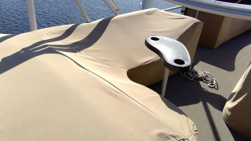 Slide: The Image of 2020 Landau Atlantis 250 Cruise boat with beige covers and a small table. - 13