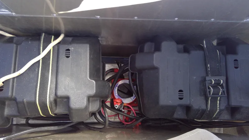 Slide: The Image of Battery compartment of 2020 Landau Atlantis 250 Cruise boat with cables and secured covers. - 19