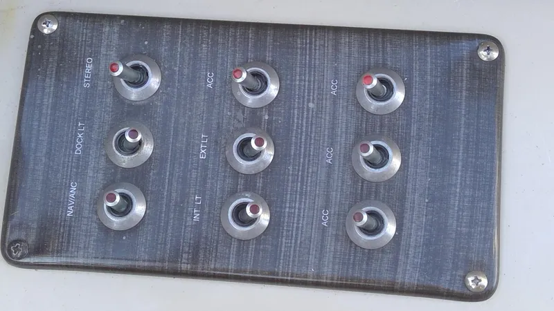 Slide: The Image of Control panel with switches on a 2020 Landau Atlantis 250 Cruise boat. - 21