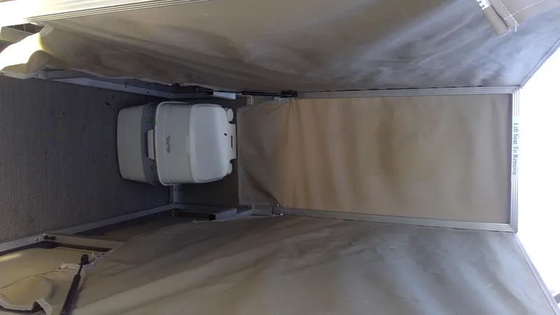 Slide: The Image of 2020 Landau Atlantis 250 Cruise interior with portable toilet setup. - 27