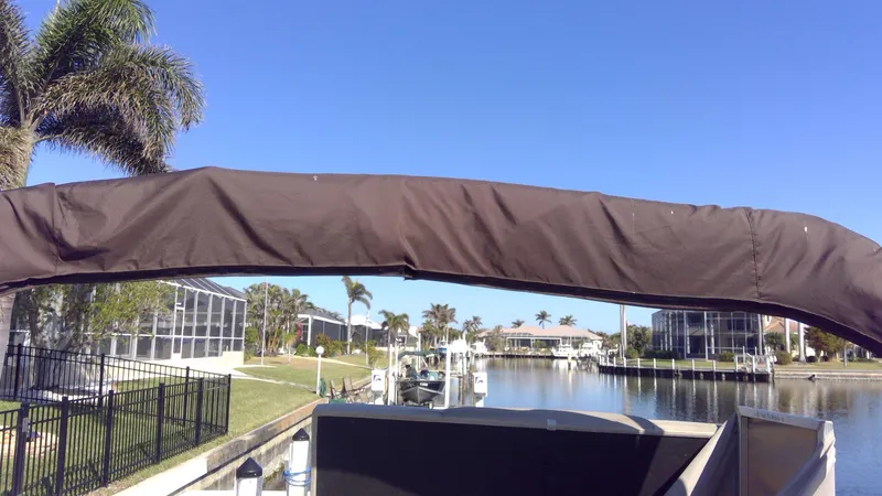 Slide: The Image of Landau Atlantis 250 Cruise boat on a sunny canal with palm trees, 2020 model. - 3