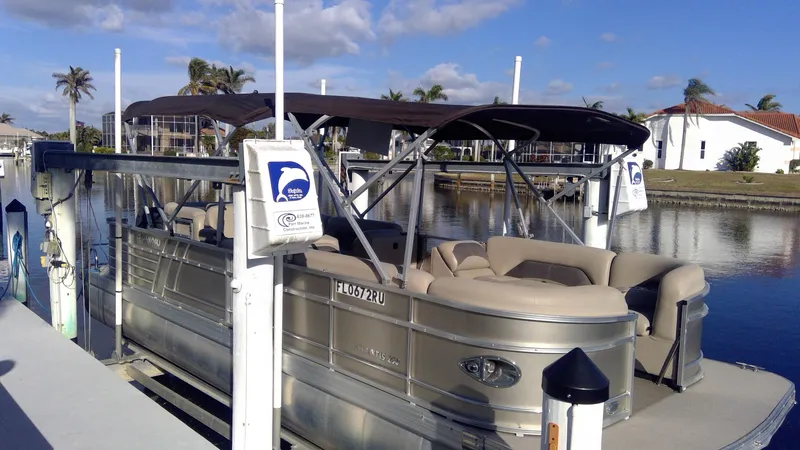 Slide: The Image of 2020 Landau Atlantis 250 Cruise pontoon boat docked by a scenic waterfront. - 33