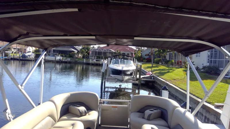 Slide: The Image of 2020 Landau Atlantis 250 Cruise pontoon boat docked in a scenic canal setting. - 37