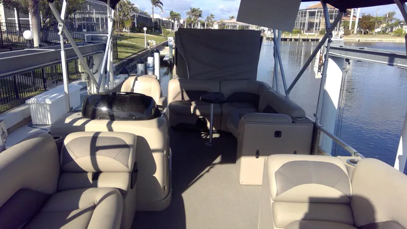 Slide: The Image of 2020 Landau Atlantis 250 Cruise pontoon boat interior with beige seating and waterfront view. - 38