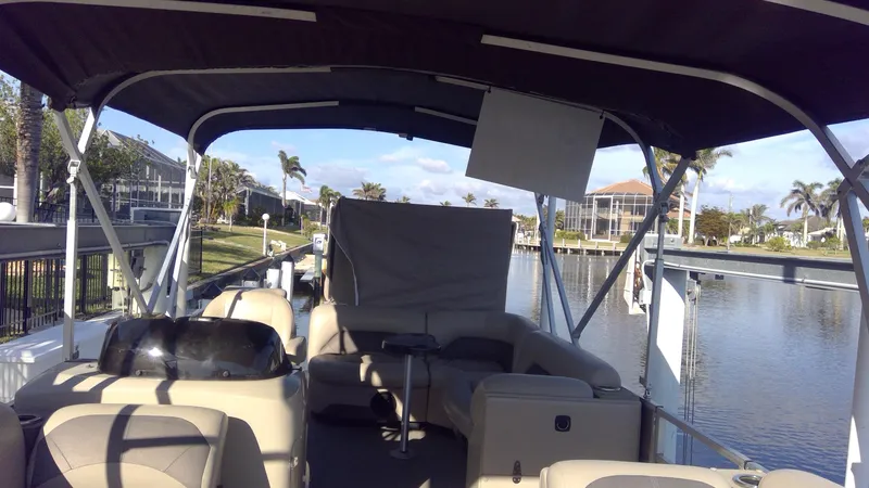 Slide: The Image of 2020 Landau Atlantis 250 Cruise pontoon boat docked by waterfront homes. - 39