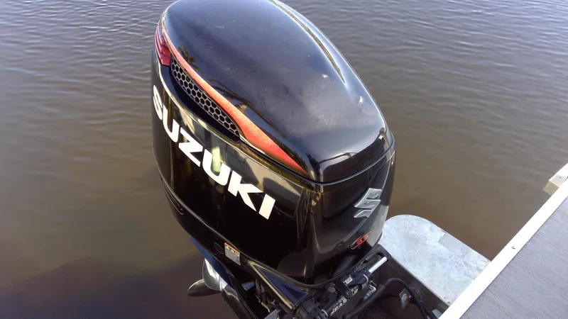 Slide: The Image of Suzuki outboard motor on 2020 Landau Atlantis 250 Cruise boat, docked on calm water. - 5