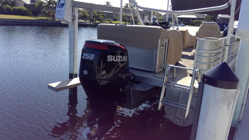 Slide: The Image of 2020 Landau Atlantis 250 Cruise with Suzuki 250 outboard motor docked by a canal. - 6