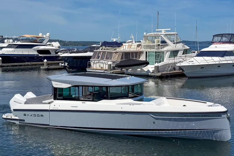 The Image of 2025 Saxdor 320 GTC boat docked at a marina, surrounded by other yachts. - 0