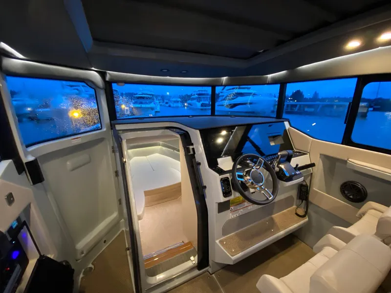 Slide: The Image of Interior of 2025 Saxdor 320 GTC boat with modern helm and panoramic windows. - 16