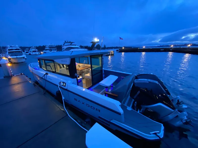 Slide: The Image of 2025 Saxdor 320 GTC boat docked at marina during twilight. - 8