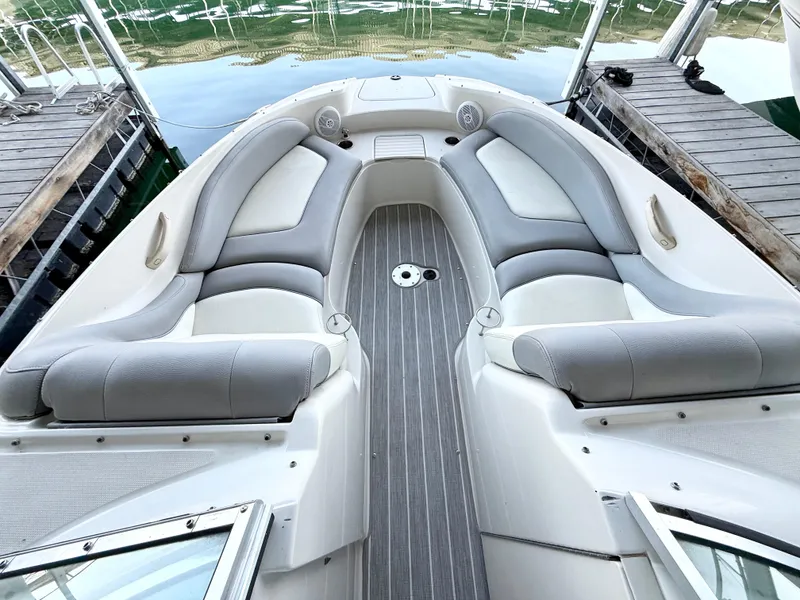 Slide: The Image of 2003 Sea Ray 270 Sundeck boat interior with gray seating and wood-style flooring. - 11
