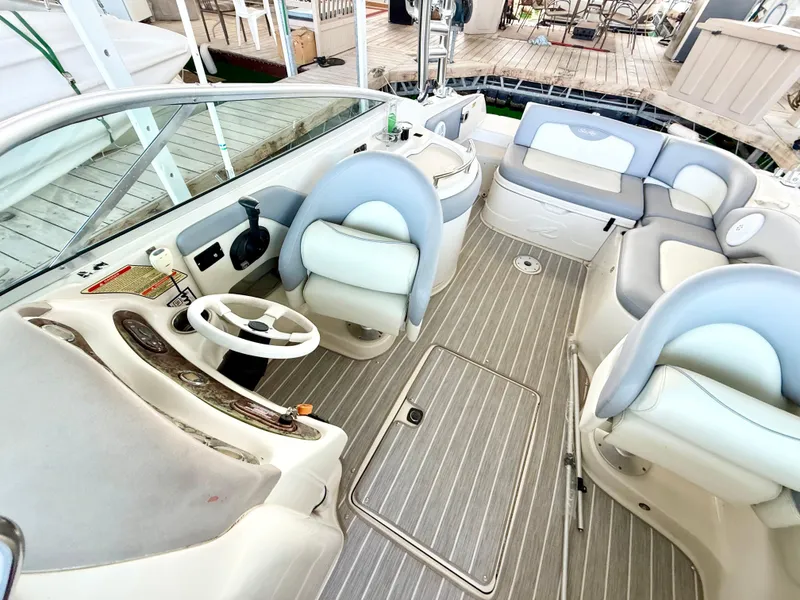 Slide: The Image of 2003 Sea Ray 270 Sundeck interior with seating, steering wheel, and deck view. - 13