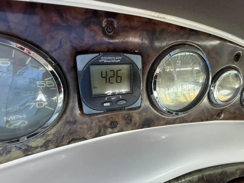 Slide: The Image of Dashboard of a 2003 Sea Ray 270 Sundeck showing gauges and digital display. - 19