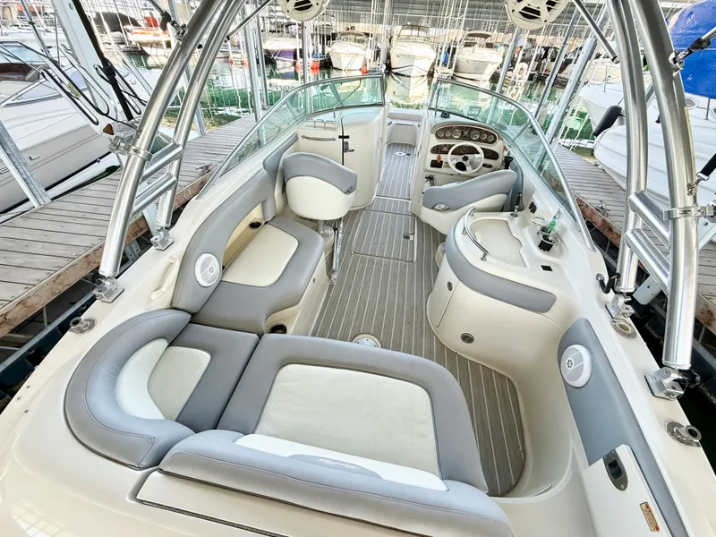 Slide: The Image of 2003 Sea Ray 270 Sundeck interior with spacious seating and modern helm. - 2