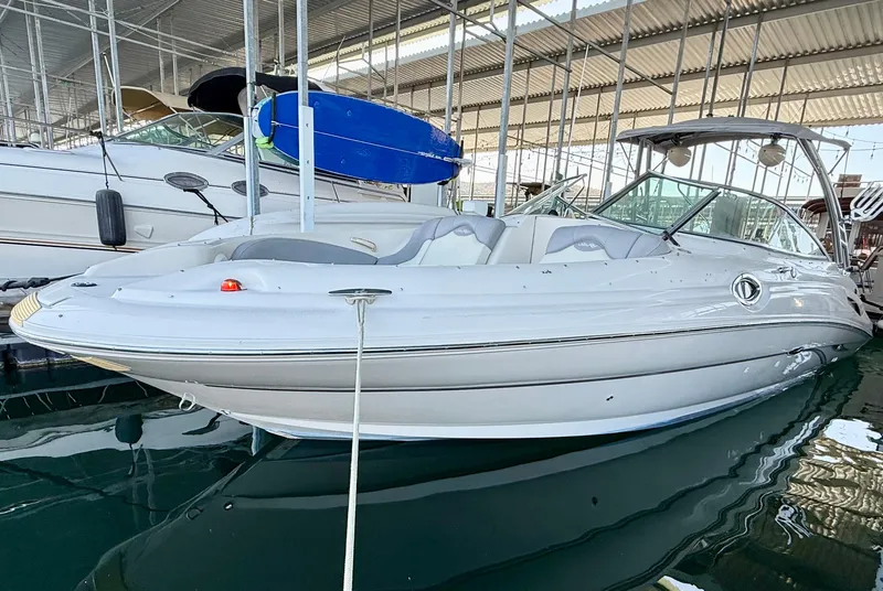 Slide: The Image of 2003 Sea Ray 270 Sundeck boat docked in a marina under a covered structure. - 20