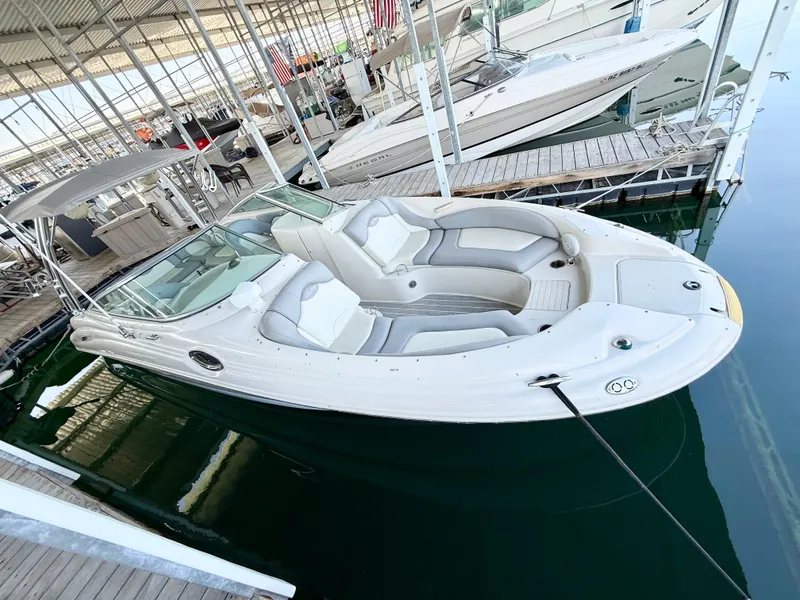 Slide: The Image of 2003 Sea Ray 270 Sundeck boat docked in a marina, featuring spacious seating. - 3
