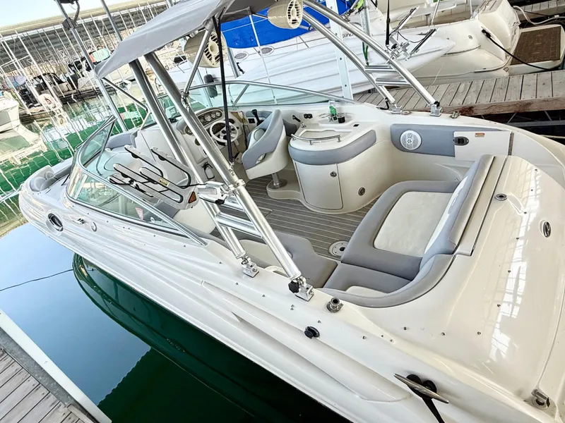 Slide: The Image of 2003 Sea Ray 270 Sundeck boat docked, featuring spacious seating and sleek design. - 4