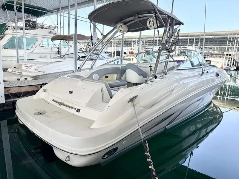 Slide: The Image of 2003 Sea Ray 270 Sundeck boat docked in marina, featuring sleek design and spacious seating. - 7