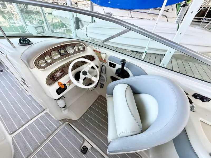 Slide: The Image of 2003 Sea Ray 270 Sundeck helm with steering wheel and control panel. - 8