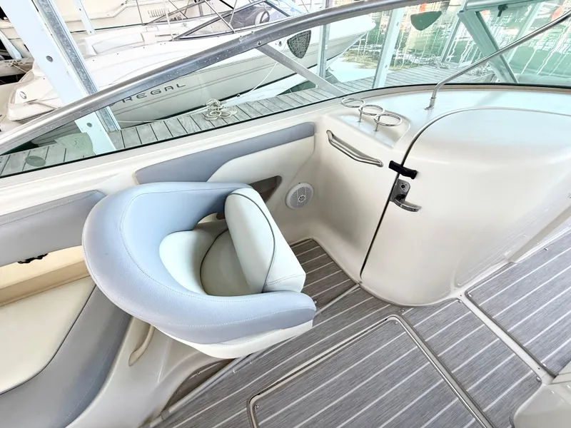 Slide: The Image of 2003 Sea Ray 270 Sundeck interior with helm seat and dashboard. - 9
