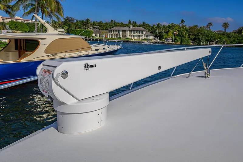 Slide: The Image of Viking 68 Convertible 2007 yacht deck with davit crane, docked near luxury boats. - 16