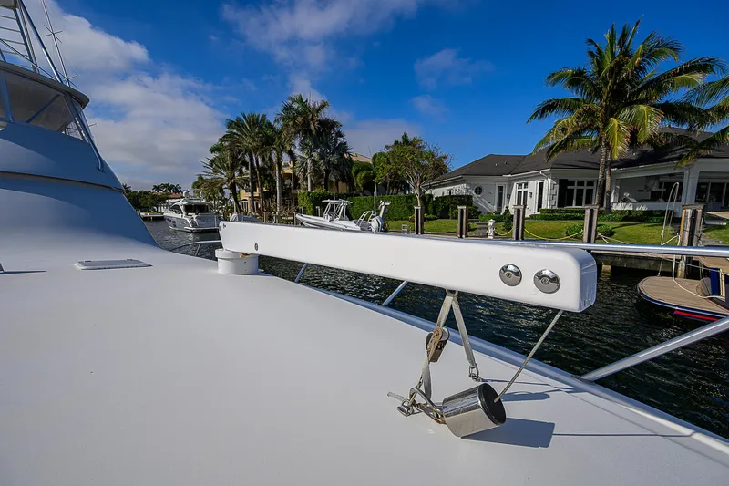 Slide: The Image of Viking 68 Convertible yacht deck, 2007 model, docked near waterfront homes and palm trees. - 19