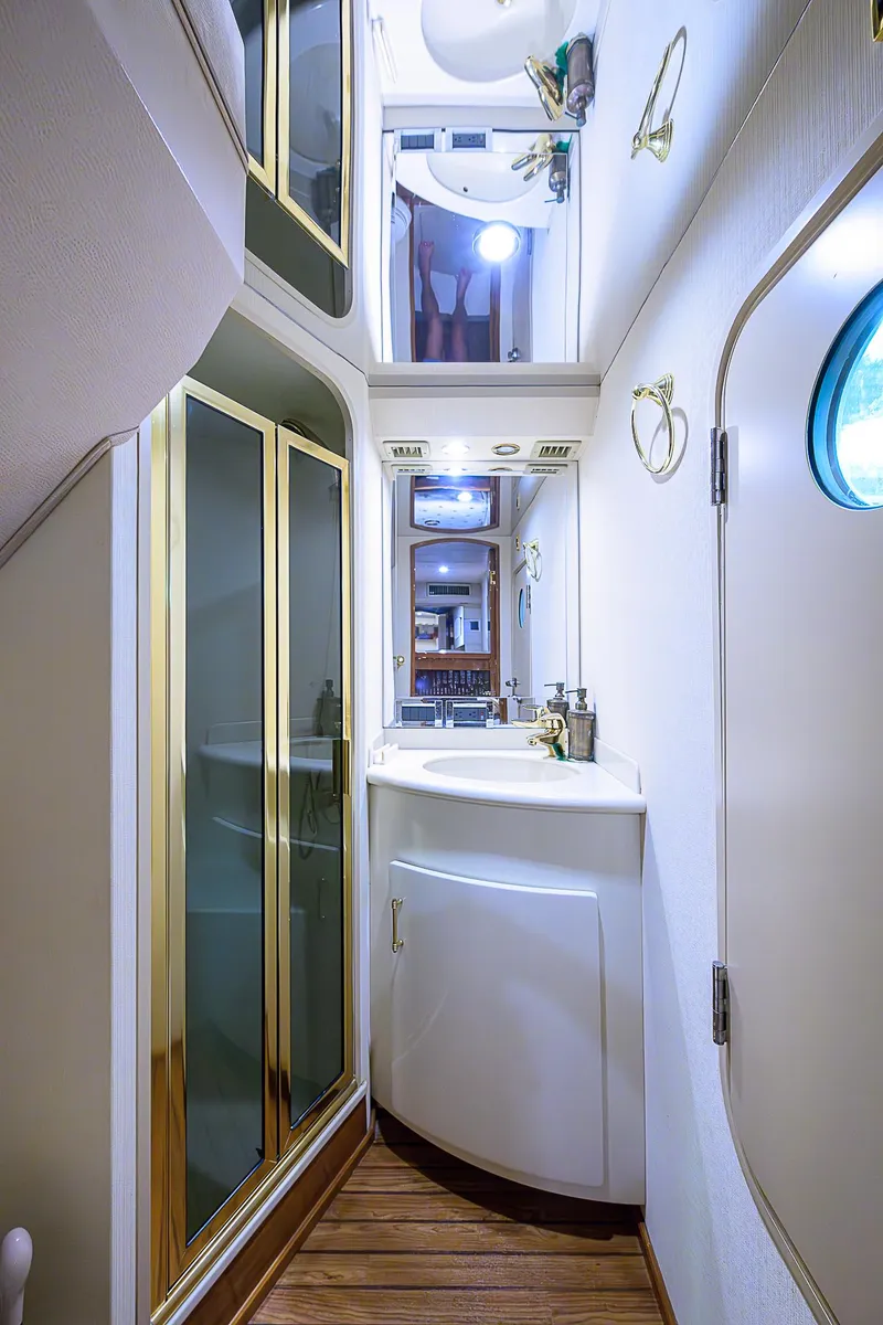 Slide: The Image of Luxurious bathroom in 2007 Viking 68 Convertible yacht with modern fixtures and wood flooring. - 22