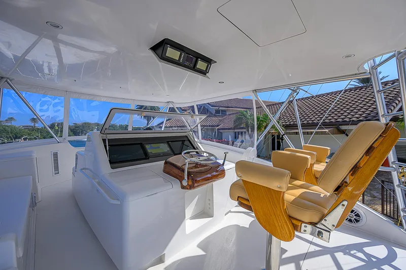 Slide: The Image of Luxurious helm of 2007 Viking 68 Convertible yacht with plush seating and modern controls. - 47