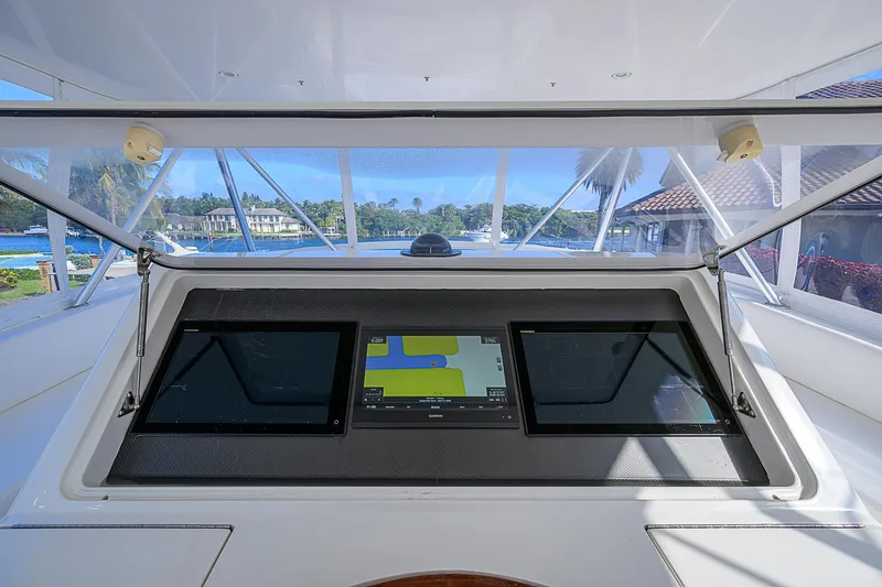 Slide: The Image of Viking 68 Convertible 2007 yacht helm with navigation screens and waterfront view. - 49