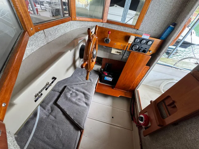 Slide: The Image of Interior of 1990 Ranger Tugs R21 Classic boat with wooden helm and control panel. - 20